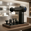 Black handheld grooming device with attachments on a wooden stand in a bathroom setting