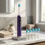 Purple electric toothbrush with multiple brush heads on a bathroom counter.